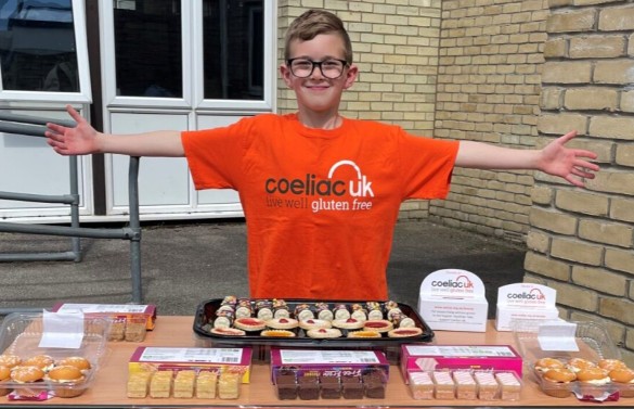 boy with arms wide selling cakes