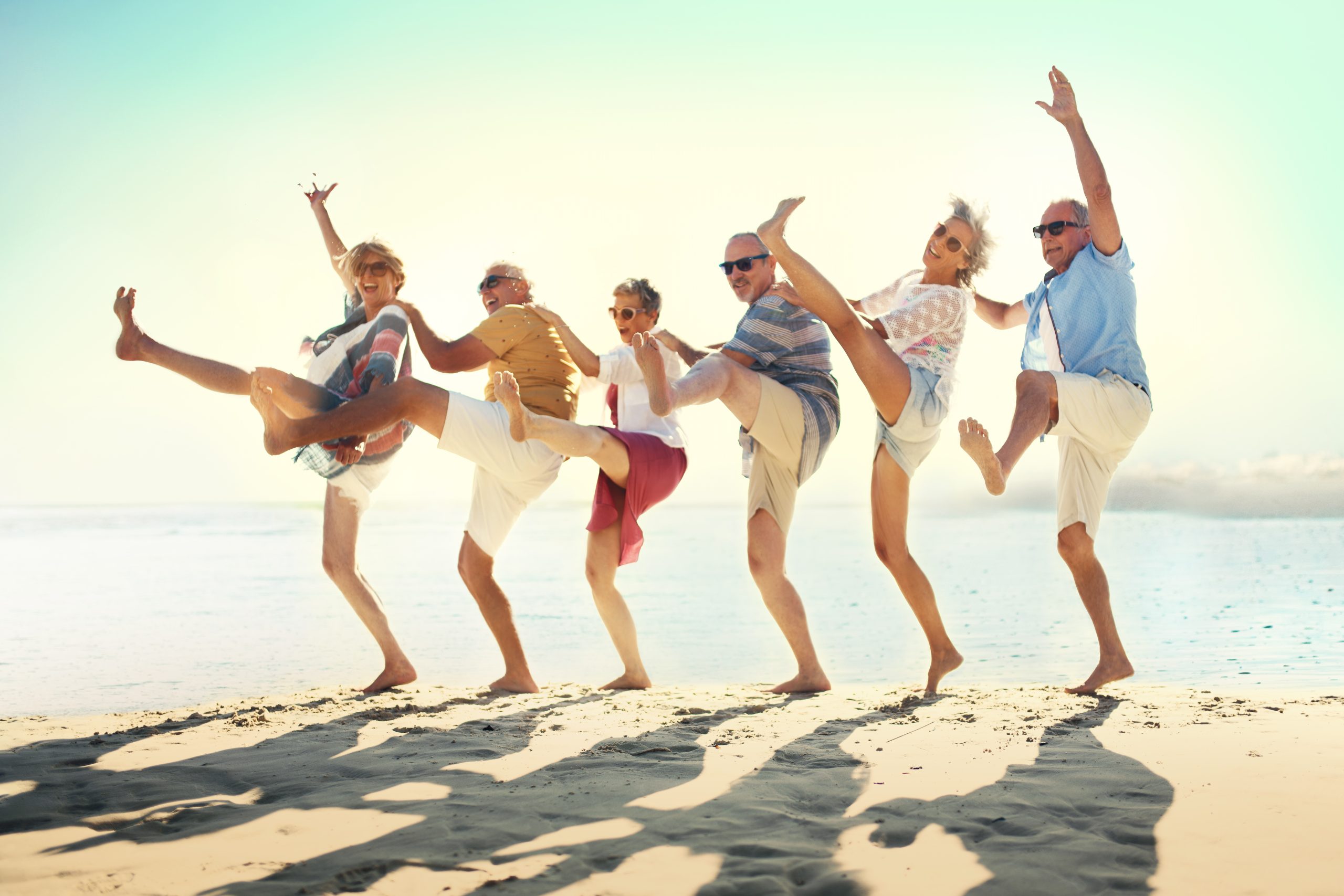 group of people dancing on a beach